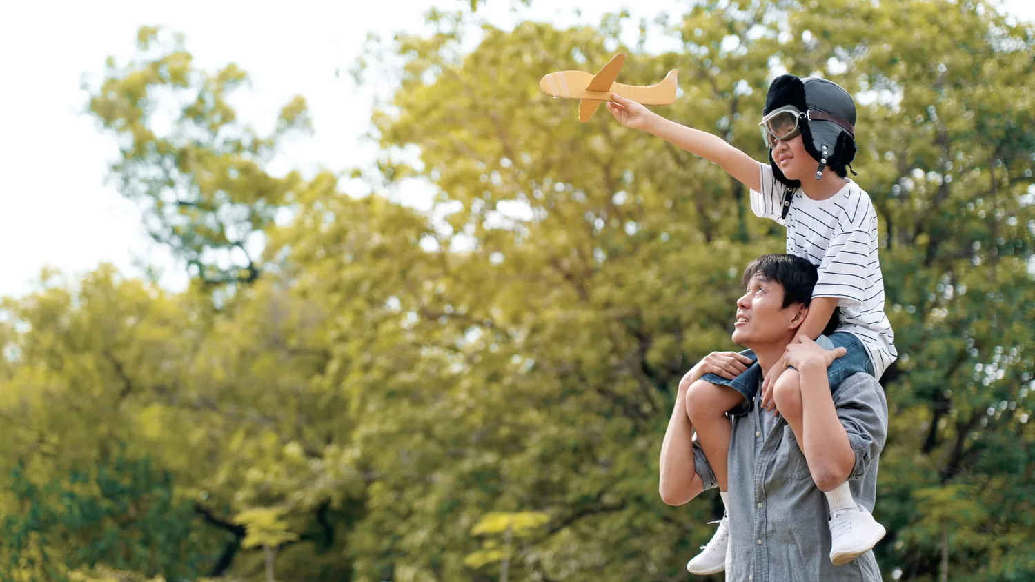 A father carrying his child outdoors